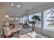 Bright sun room with tile floors, sun-blocking blinds, and comfortable furniture at 11926 Milan Way, Leesburg, FL 34788