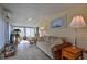 Light and airy sun room with ample seating, art, and decor at 11926 Milan Way, Leesburg, FL 34788