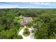 Aerial view of estate featuring a circular driveway, mature trees, and beautiful landscaping at 1325 Otters View Ct, Fruitland Park, FL 34731