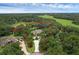 Expansive property featuring a circular drive, mature trees, and lush landscaping, all surrounded by beautiful nature at 1325 Otters View Ct, Fruitland Park, FL 34731