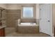 Bathroom with tub, tiled shower, and privacy window at 1325 Otters View Ct, Fruitland Park, FL 34731