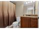 Standard bathroom showcasing a vanity, granite countertop,framed mirror, decorative lighting, toilet, and shower with curtain at 1325 Otters View Ct, Fruitland Park, FL 34731