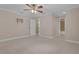 Large bedroom with an open hall and bathroom and neutral carpet at 1325 Otters View Ct, Fruitland Park, FL 34731