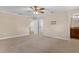 Large bedroom with neutral carpet, an open doorway, and an en-suite bath and hall at 1325 Otters View Ct, Fruitland Park, FL 34731
