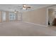 Expansive bedroom featuring neutral carpet, crown molding, and bright windows with plantation shutters at 1325 Otters View Ct, Fruitland Park, FL 34731