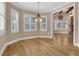 Inviting dining area featuring hardwood floors, modern chandelier, and plantation shutters at 1325 Otters View Ct, Fruitland Park, FL 34731