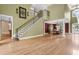 The foyer showcases an elegant staircase and transitions seamlessly to the dining room at 1325 Otters View Ct, Fruitland Park, FL 34731