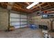 Spacious garage with ample storage shelving and a functional layout, providing secure parking and organization at 1325 Otters View Ct, Fruitland Park, FL 34731