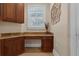 Home office features granite countertops, custom cabinets and a window with plantation shutters at 1325 Otters View Ct, Fruitland Park, FL 34731