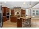 Gourmet kitchen with stone accents, custom cabinets, and granite countertops and central island at 1325 Otters View Ct, Fruitland Park, FL 34731