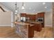 This kitchen showcases stone accents, pendant lighting, and wooden cabinets for a rustic feel at 1325 Otters View Ct, Fruitland Park, FL 34731