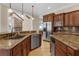 Open kitchen with stainless steel appliances, granite counters, and abundant cabinet space at 1325 Otters View Ct, Fruitland Park, FL 34731