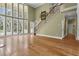 Bright living room featuring hardwood floors, fireplace, staircase, and large windows overlooking pool at 1325 Otters View Ct, Fruitland Park, FL 34731