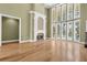 Bright living room boasts a fireplace, hardwood floors, and a wall of windows overlooking the pool at 1325 Otters View Ct, Fruitland Park, FL 34731