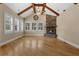 Spacious living room with stone fireplace, wood beams and plenty of natural light at 1325 Otters View Ct, Fruitland Park, FL 34731