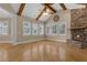 Bright living room with wood beams, stone fireplace and hardwood floors at 1325 Otters View Ct, Fruitland Park, FL 34731