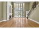 Elegant living room featuring a fireplace, staircase, hardwood floors, and ample natural light at 1325 Otters View Ct, Fruitland Park, FL 34731