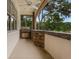 Covered outdoor kitchen with stone countertops and a built-in grill at 1325 Otters View Ct, Fruitland Park, FL 34731