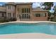 Backyard swimming pool and spa with brick home in the background at 1325 Otters View Ct, Fruitland Park, FL 34731