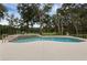 An inground swimming pool and spa with views of the lush backyard at 1325 Otters View Ct, Fruitland Park, FL 34731