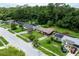 Serene aerial view showcases the home in a quiet neighborhood with mature trees and green spaces at 1415 Braebury Dr, Leesburg, FL 34748