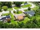 Aerial view of home with a detached garage, and a well-maintained lawn at 1415 Braebury Dr, Leesburg, FL 34748