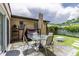 Back patio with patio furniture, a swing, a table, and a closed tan umbrella at 1415 Braebury Dr, Leesburg, FL 34748