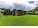 Backyard featuring a well-manicured lawn and partial view of a home's exterior and the surrounding fence line at 1415 Braebury Dr, Leesburg, FL 34748