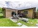Backyard area features a patio area, and a manicured lawn with landscaping at 1415 Braebury Dr, Leesburg, FL 34748