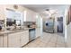 Bright kitchen featuring stainless steel appliances, white cabinets, and granite countertops at 1415 Braebury Dr, Leesburg, FL 34748