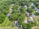Aerial view of homes nestled among the trees in a residential neighborhood at 1511 W Magnolia St, Clermont, FL 34711