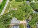 Overhead view of a home surrounded by mature trees, showcasing its serene setting at 1511 W Magnolia St, Clermont, FL 34711