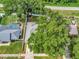 Aerial view of a property with a private pool, lush landscaping, and mature trees at 1511 W Magnolia St, Clermont, FL 34711