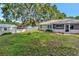 Spacious backyard with lawn, privacy fence, and storage shed at 1511 W Magnolia St, Clermont, FL 34711