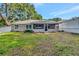Large backyard with screened-in porch, lawn, and privacy fence at 1511 W Magnolia St, Clermont, FL 34711