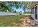 Backyard featuring a lawn, privacy fence, and storage shed in a natural setting at 1511 W Magnolia St, Clermont, FL 34711
