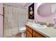 Bathroom with a single sink vanity, a toilet, and a shower with a decorative curtain at 1511 W Magnolia St, Clermont, FL 34711