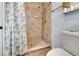 Bathroom featuring a tiled stand up shower with a curtain and toilet at 1511 W Magnolia St, Clermont, FL 34711