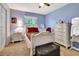 Bright bedroom featuring a white bed frame, dresser, and a vanity area with natural light at 1511 W Magnolia St, Clermont, FL 34711