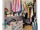Organized walk-in closet with shelves, hanging rods, and storage boxes for clothing and accessories at 1511 W Magnolia St, Clermont, FL 34711