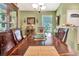 Elegant dining room with a large table, wooden chairs, and a view of the front entrance at 1511 W Magnolia St, Clermont, FL 34711