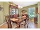 Dining room featuring a large wooden table, a china cabinet, and a window with natural light at 1511 W Magnolia St, Clermont, FL 34711