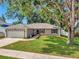 Beautifully maintained home featuring a well-manicured lawn and mature trees at 1511 W Magnolia St, Clermont, FL 34711