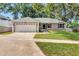 Charming single-story home with a well-manicured lawn and two-car garage at 1511 W Magnolia St, Clermont, FL 34711