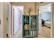 Hallway with a display case featuring books and decor, with access to a bathroom and a bedroom at 1511 W Magnolia St, Clermont, FL 34711