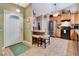 Inviting kitchen next to the entrance, with an eat-in island and stainless steel refrigerator at 1511 W Magnolia St, Clermont, FL 34711