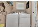 Well-lit laundry room features a modern washer and dryer, enhancing the home's functionality at 1511 W Magnolia St, Clermont, FL 34711