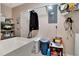 Functional laundry room includes a utility sink, storage shelves, and hanging rod for convenience at 1511 W Magnolia St, Clermont, FL 34711