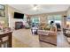 Spacious living room featuring tile flooring, a fireplace, and a large window for natural light at 1511 W Magnolia St, Clermont, FL 34711