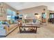Cozy living room with high ceilings, warm colors, and a view into other areas of the home at 1511 W Magnolia St, Clermont, FL 34711